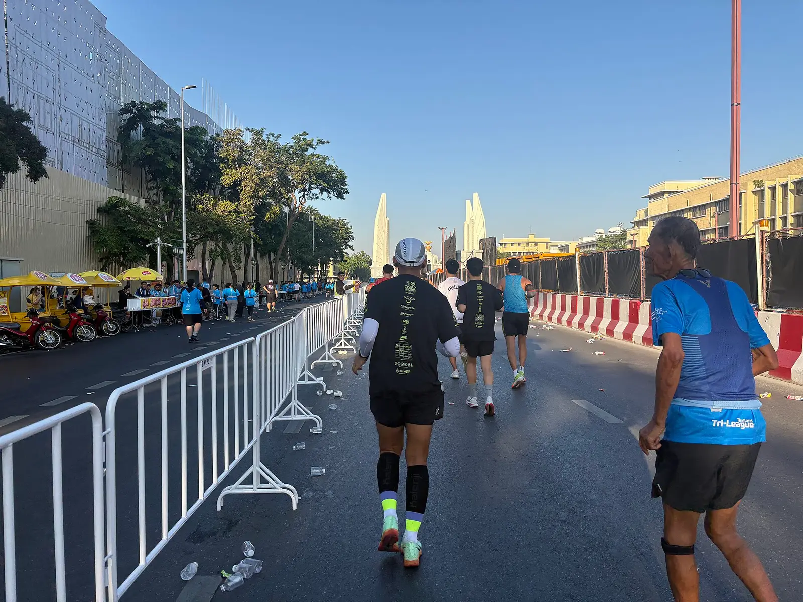 Runners on a closed Bangkok road near Democracy Monument during the 2025 marathon