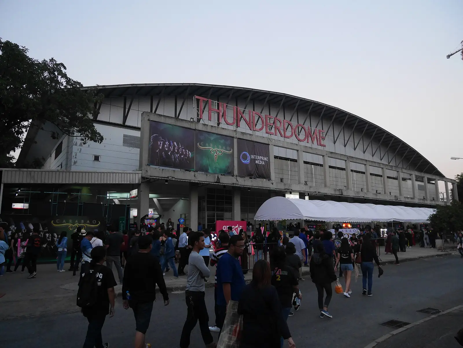 Crowds gathering outside the Impact Arena entrance at Muang Thong Thani under its large roof