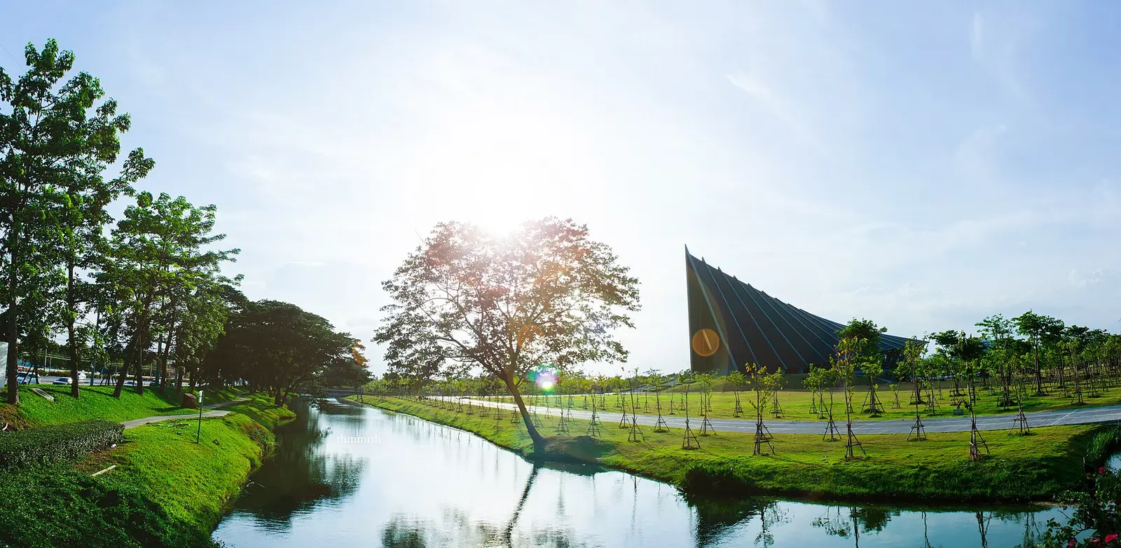 Prince Mahidol Hall at Mahidol University with a canal and lawns in the foreground