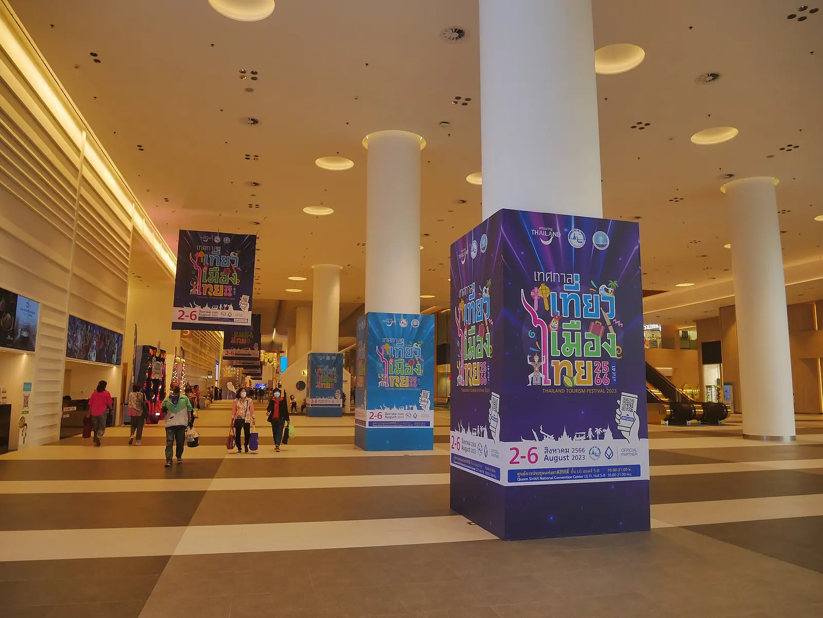 Wide concourse inside the Queen Sirikit National Convention Centre with expo banners on the pillars