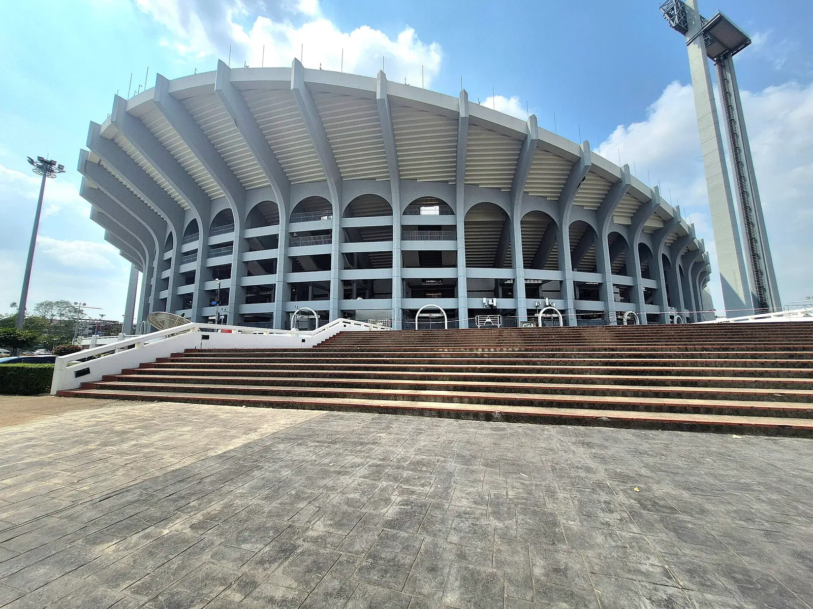 The curved outer bowl and entrance steps of Rajamangala National Stadium