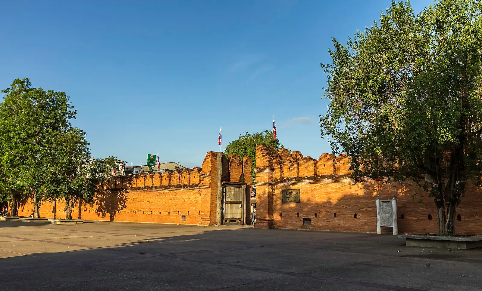 Tha Phae Gate and the old brick city wall of Chiang Mai in low evening light